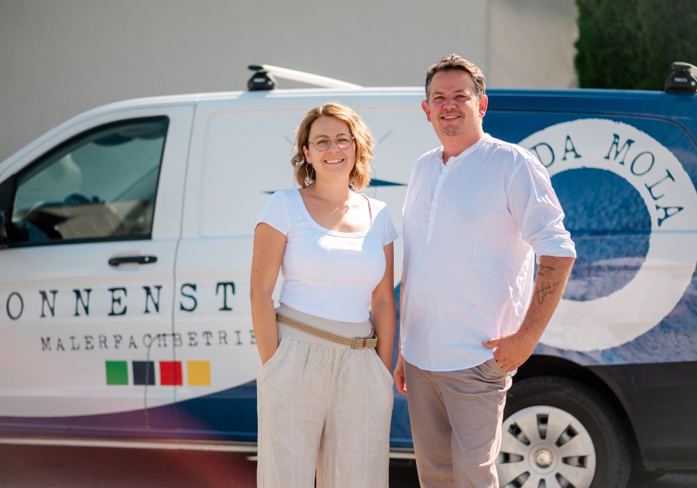 Die Inhaber des steirischen Betriebes für Wand- und Raumgestaltung, Markus und Melanie, vor Ihrem Fahrzeug in Gleisdorf.
